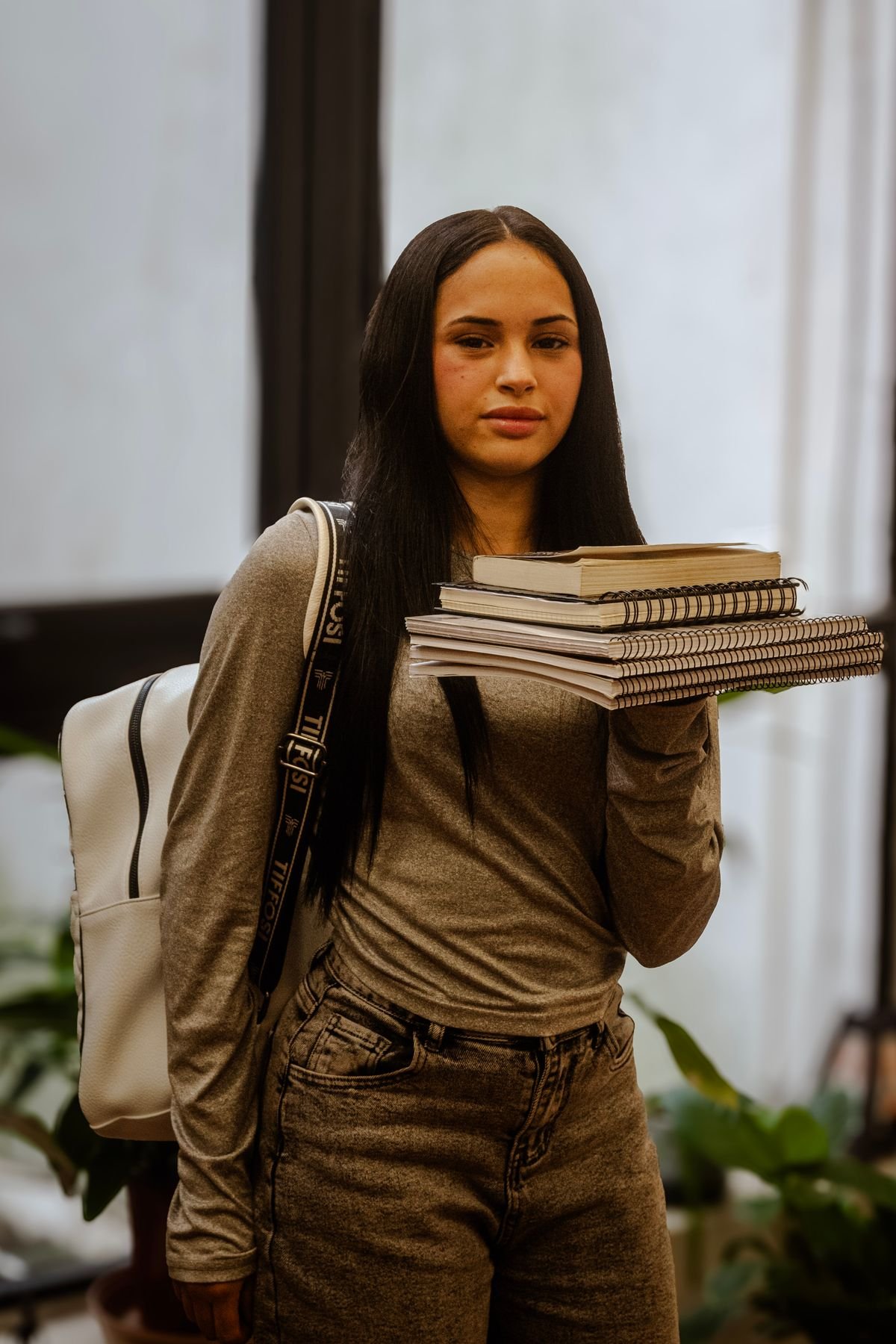 Student with books and a backpack, ready to study abroad
